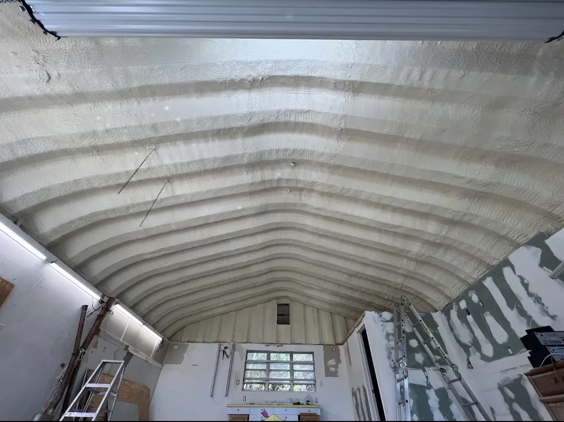 Spray polyurethane foam applied to the underside of a metal roof deck in Gustine